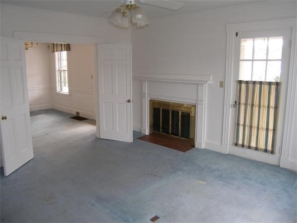 8-10 Concord Road Sudbury, MA 01776 - Photo 12 of 37 an empty room with windows and fireplace