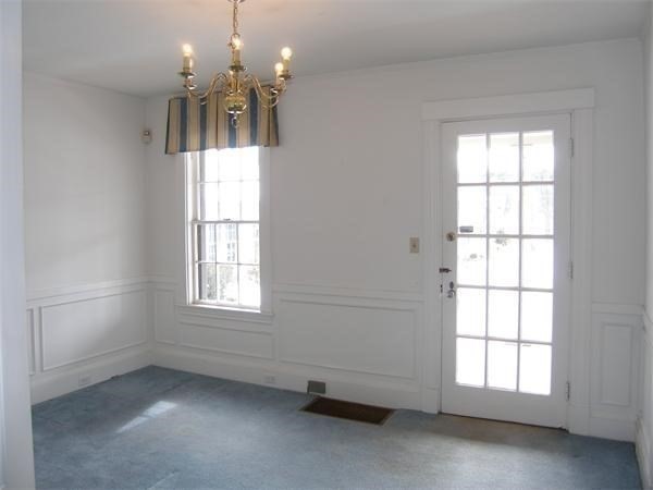 8-10 Concord Road Sudbury, MA 01776 - Photo 13 of 37 an empty room with a windows and chandelier