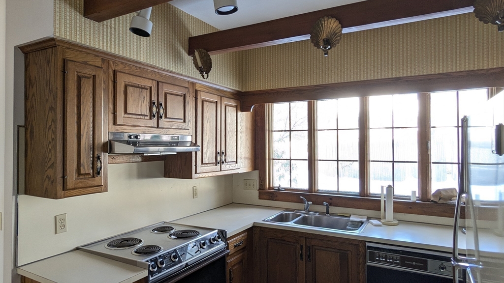 8-10 Concord Road Sudbury, MA 01776 - Photo 16 of 37 a kitchen with stainless steel appliances granite countertop a sink stove and cabinets