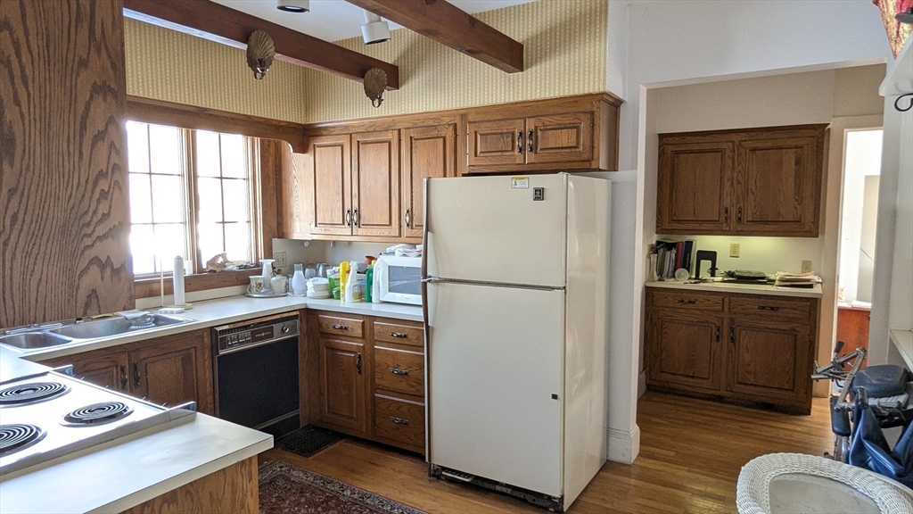 8-10 Concord Road Sudbury, MA 01776 - Photo 17 of 37 a white refrigerator freezer sitting inside of a kitchen