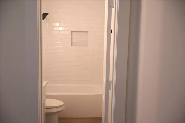 a bathroom with a granite countertop toilet a sink and bathtub