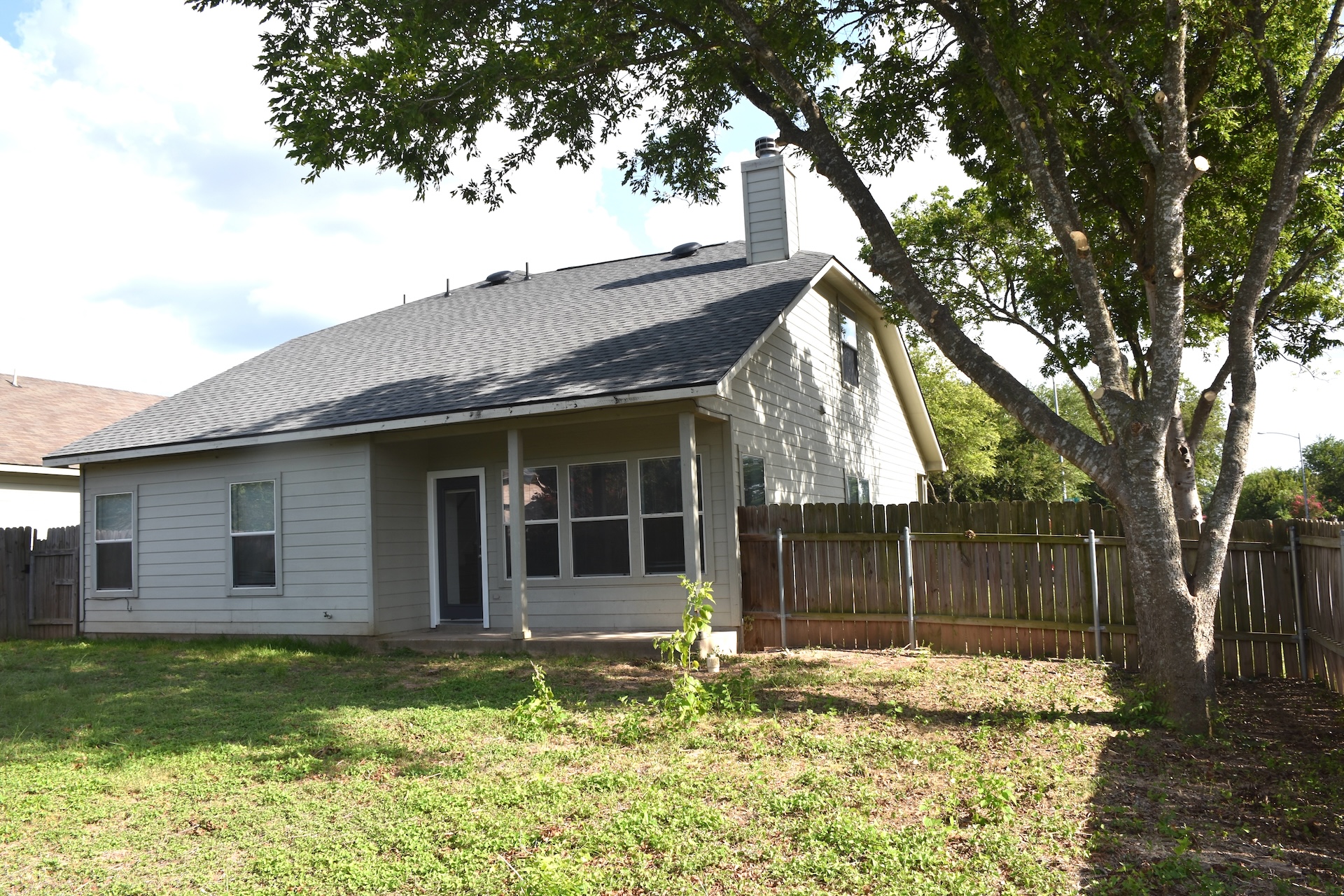 11300 Dimmit Street Manor, TX 78653 - Photo 21 of 23 A private backyard oasis with a fenced perimeter and mature shade trees.
