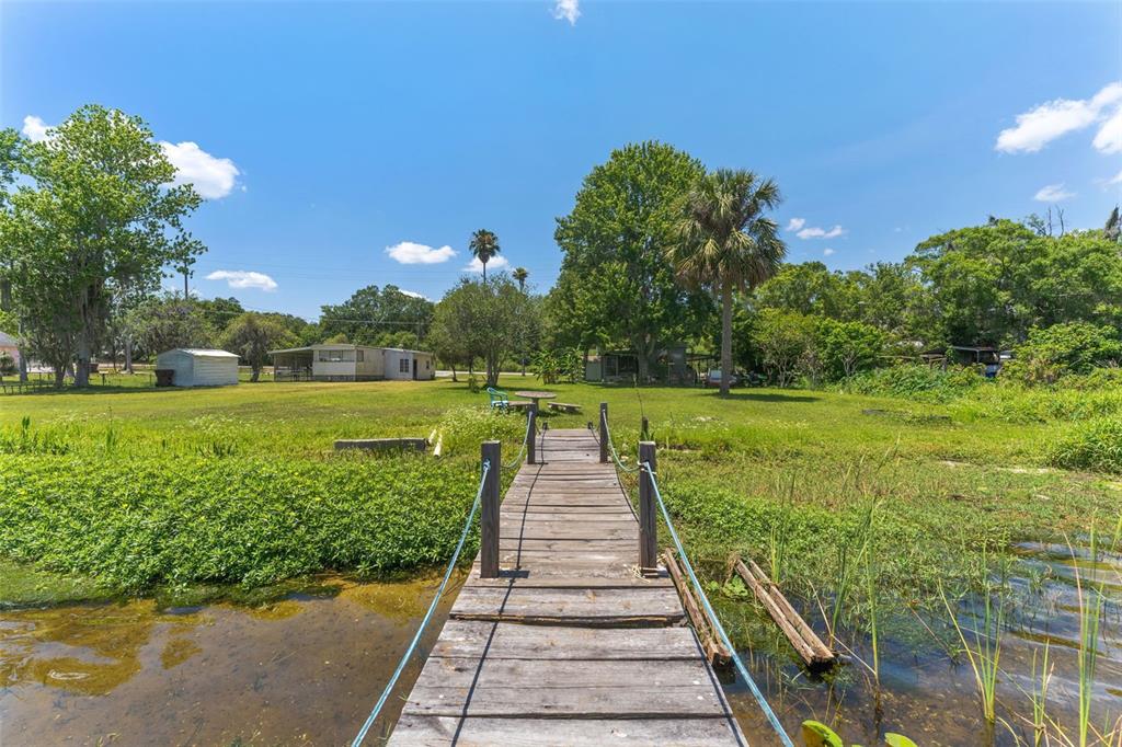 7570 Berkley Road Polk City, FL 33868 - Photo 14 of 16 a view of an outdoor space with a garden