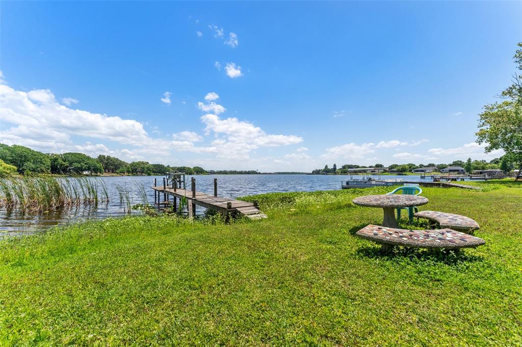 7570 Berkley Road Polk City, FL 33868 - Photo 2 of 16 a view of a lake with a yard