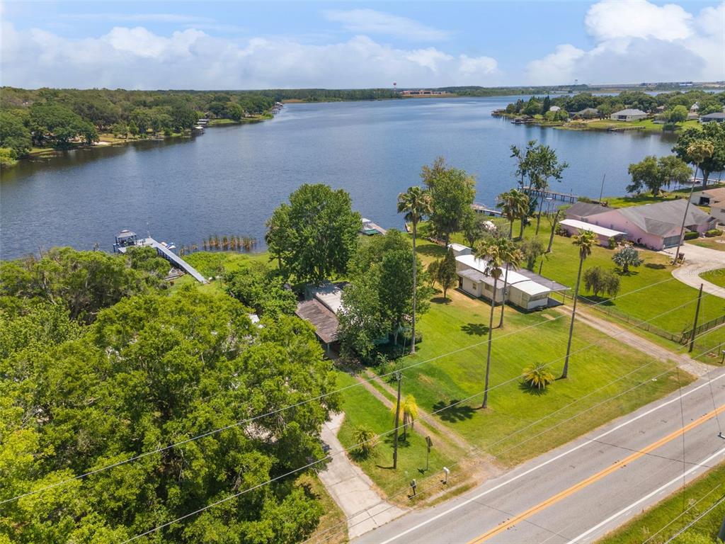 7570 Berkley Road Polk City, FL 33868 - Photo 3 of 16 an aerial view of residential houses with outdoor space and lake view