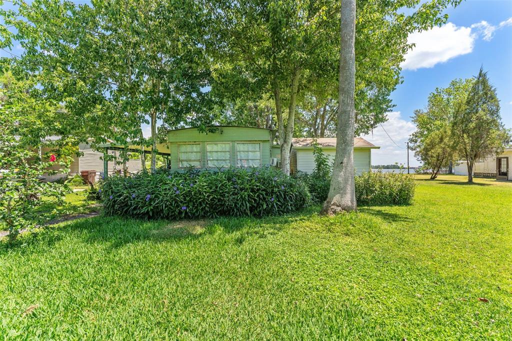 7570 Berkley Road Polk City, FL 33868 - Photo 8 of 16 a view of a garden with a lake