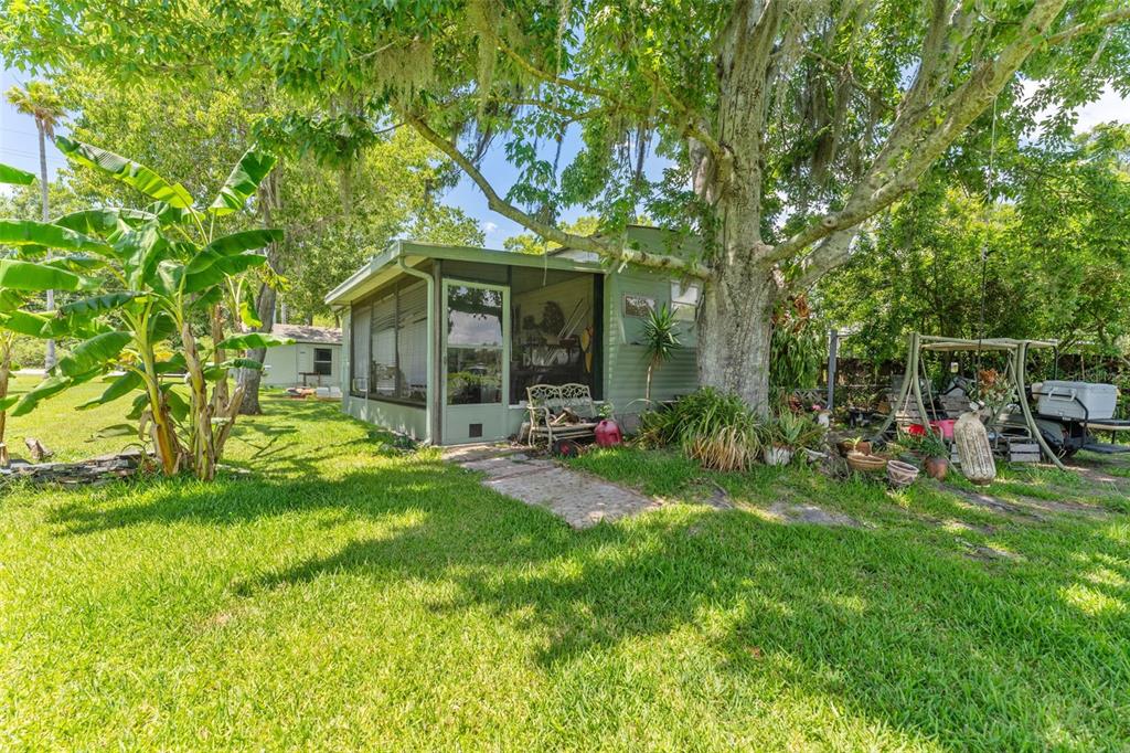 7570 Berkley Road Polk City, FL 33868 - Photo 9 of 16 a view of a chair and table in backyard of the house