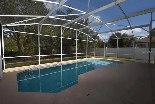 a view of a room with wooden floor and door