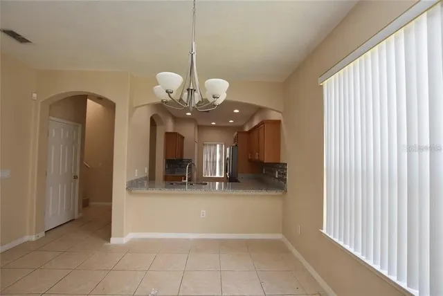 a view of a hallway with a chandelier and chandelier