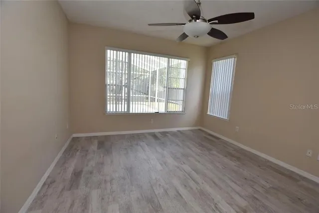 wooden floor in an empty room with a window