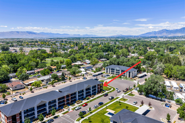 572 South 100 West, Unit E210 Springville, UT 84663 - Photo 28 of 35 Aerial perspective showcasing a multi-story building with a dark roof and brick detailing
