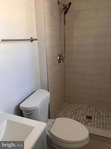 a white toilet sitting next to a bathroom sink