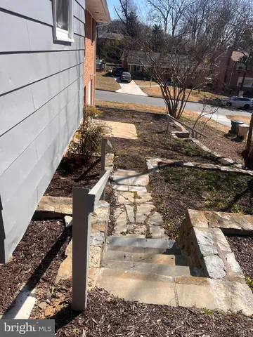 a view of a yard with wooden fence