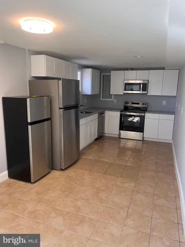 a kitchen with stainless steel appliances a refrigerator and a stove