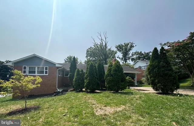 a view of a house with a yard and a garden