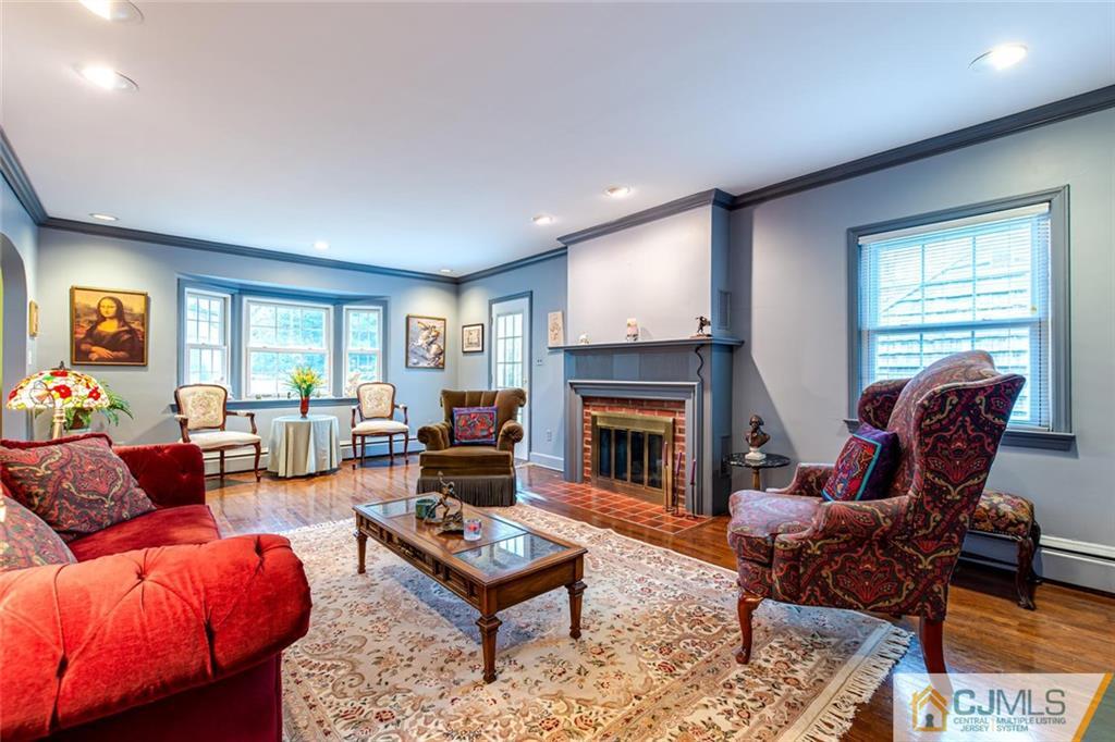 473 Plainfield Road Edison, NJ 08820 - Photo 13 of 28 a living room with furniture a rug and a fireplace