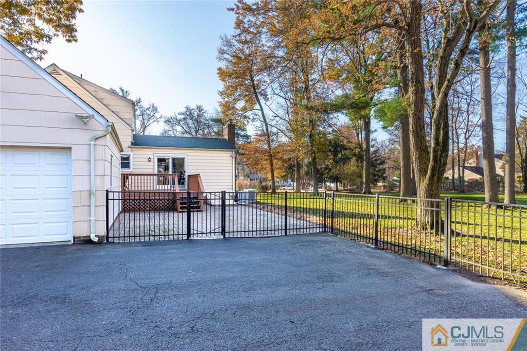 473 Plainfield Road Edison, NJ 08820 - Photo 16 of 28 a view of backyard with a small deck and a fire pit