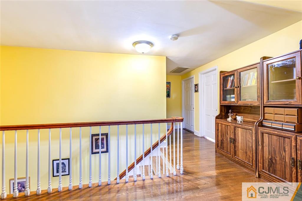 473 Plainfield Road Edison, NJ 08820 - Photo 19 of 28 a view of a hallway with wooden floor and staircase