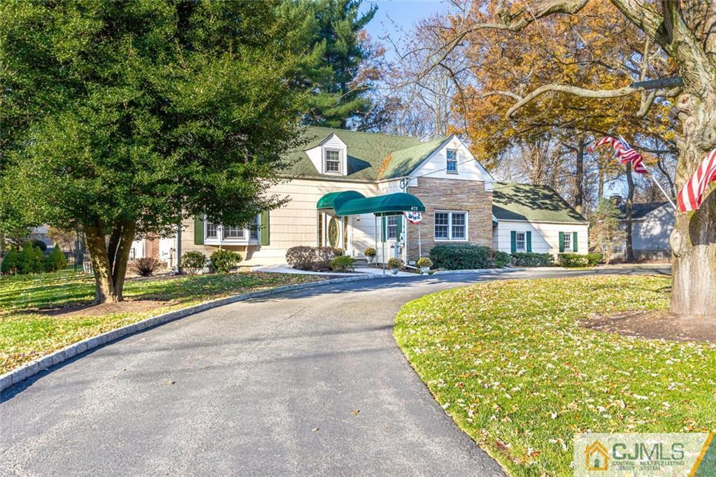 473 Plainfield Road Edison, NJ 08820 - Photo 3 of 28 a front view of a house with a yard table and chairs