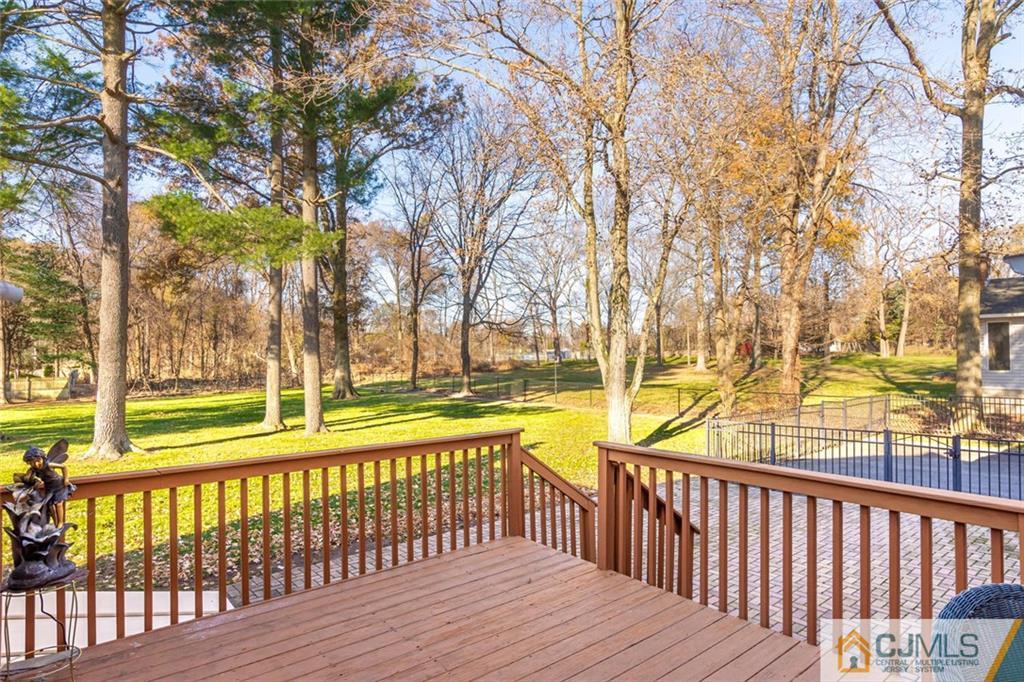 473 Plainfield Road Edison, NJ 08820 - Photo 28 of 28 a view of a wooden deck with large trees