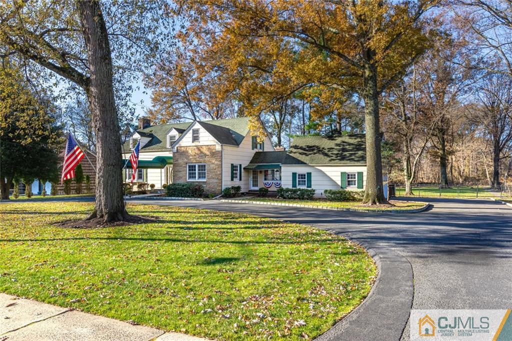 473 Plainfield Road Edison, NJ 08820 - Photo 4 of 28 a front view of a house with a big yard and large trees