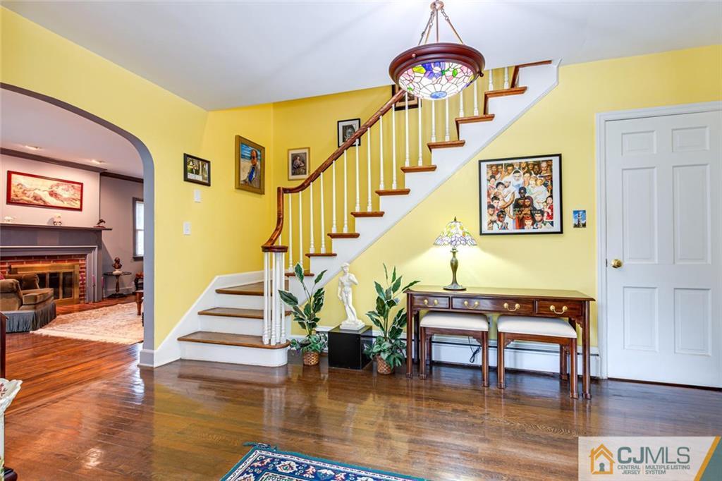 473 Plainfield Road Edison, NJ 08820 - Photo 5 of 28 a view of entryway dining room and hall with wooden floor