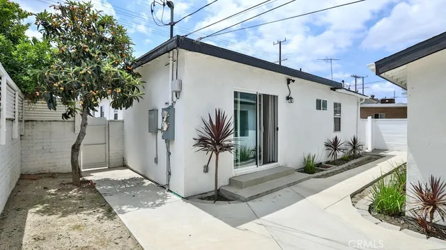 a front view of house with a garden