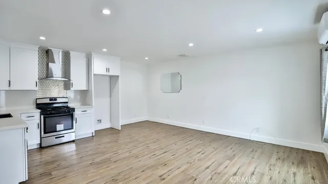 a kitchen with stainless steel appliances granite countertop a refrigerator sink and cabinets