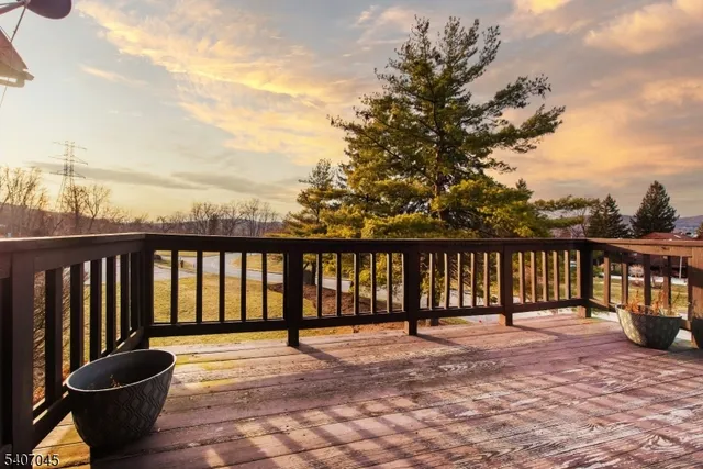 a living room with furniture a flat screen tv and a window