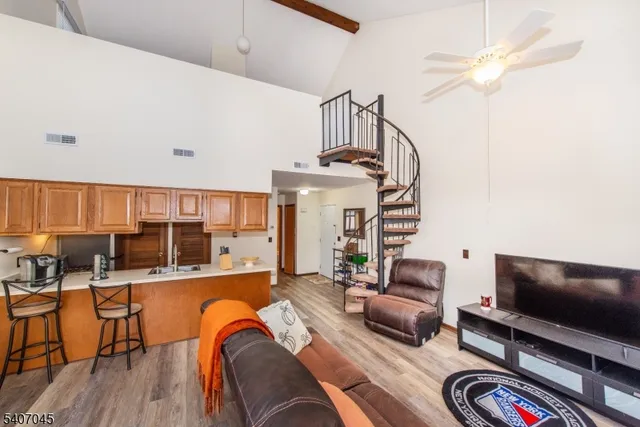 a view of a livingroom with furniture wooden floor and windows