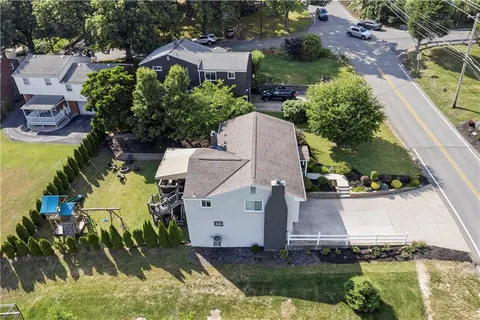 an aerial view of a house with swimming pool and outdoor space