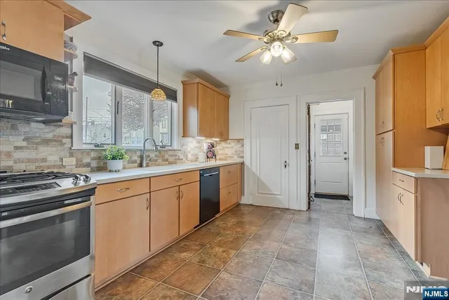 a kitchen with a sink stove and refrigerator