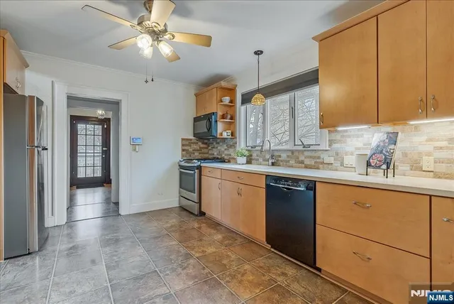 a kitchen with a sink cabinets and window