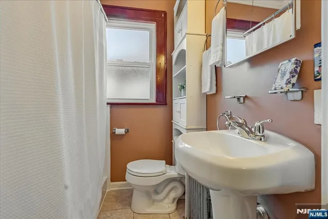 a bathroom with a sink a toilet and mirror