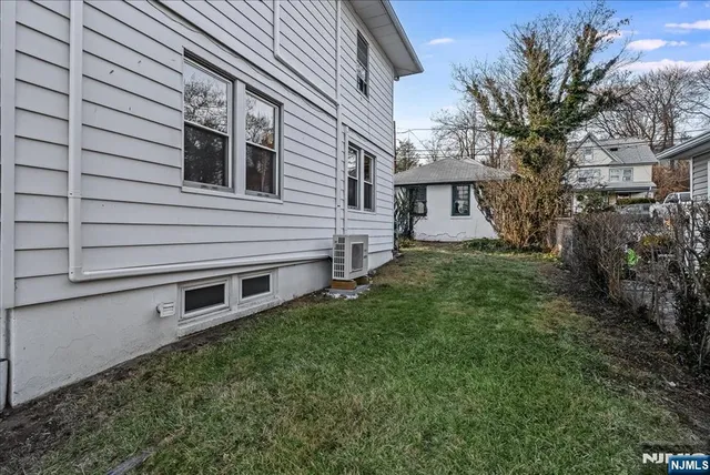 a view of house with backyard