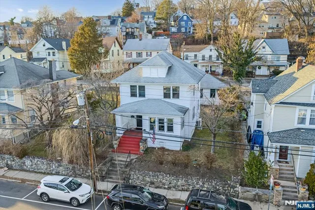 a front view of a house with a yard and mountain view