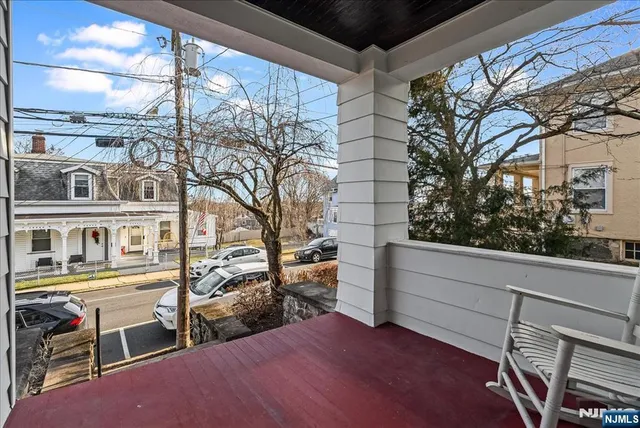 a view of balcony with furniture and trees