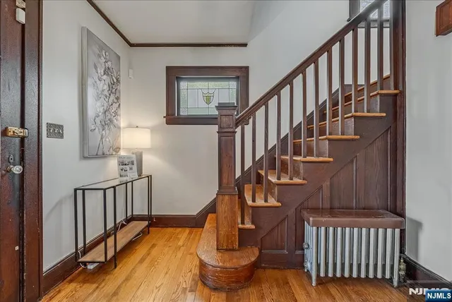a view of entryway with wooden floor and a front door