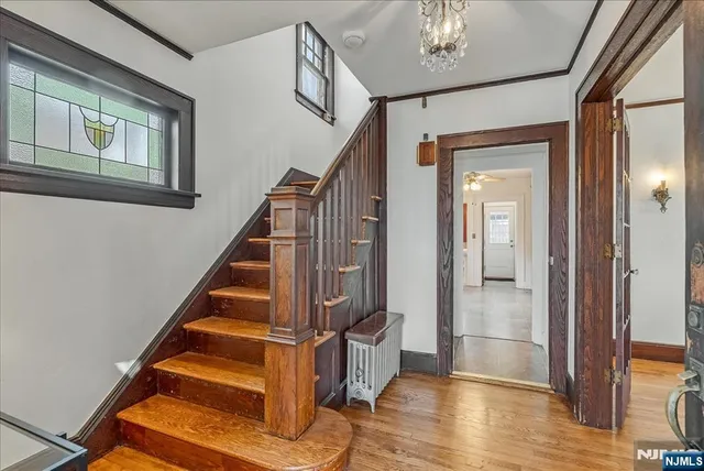a view of an entryway with wooden floor and door
