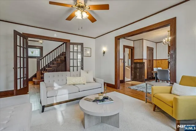 a living room with furniture and a chandelier