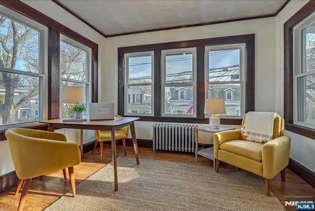 a view of a dining room with furniture wooden floor and windows