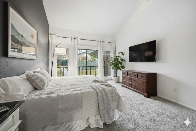 a spacious bedroom with a bed and large window