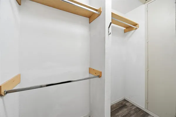 a bedroom with a bed and a ceiling fan