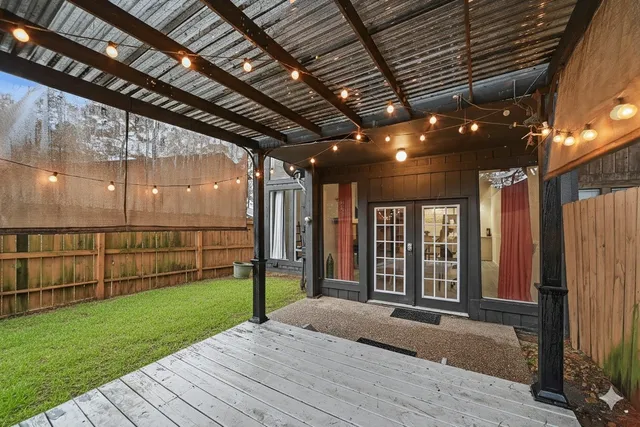 a view of a house with many window and wooden fence