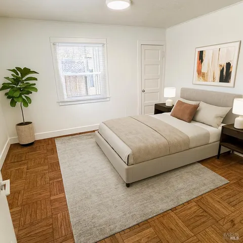 a bedroom with a bed lamp and a potted plant