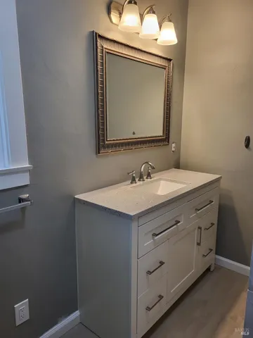 a bathroom with a sink vanity and a mirror