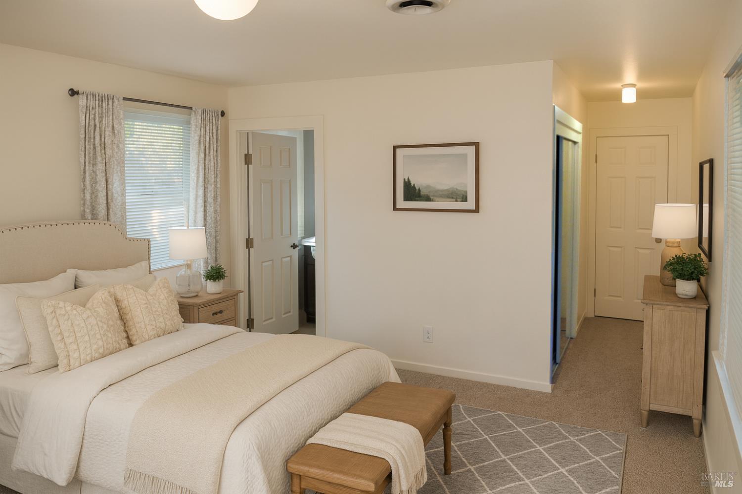 829 Hunt Avenue, Unit A St. Helena, CA 94574 - Photo 9 of 13 a bedroom with a bed and a view of bathroom