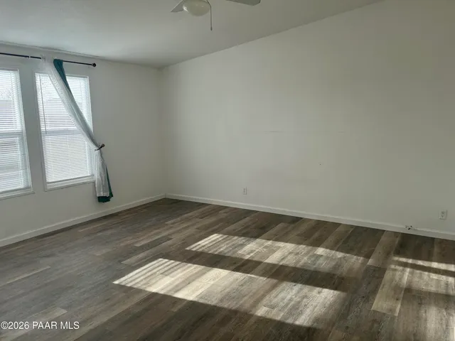 a view of a room with wooden floor and window