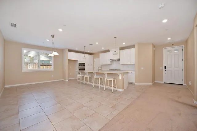 a view of a kitchen with white cabinets