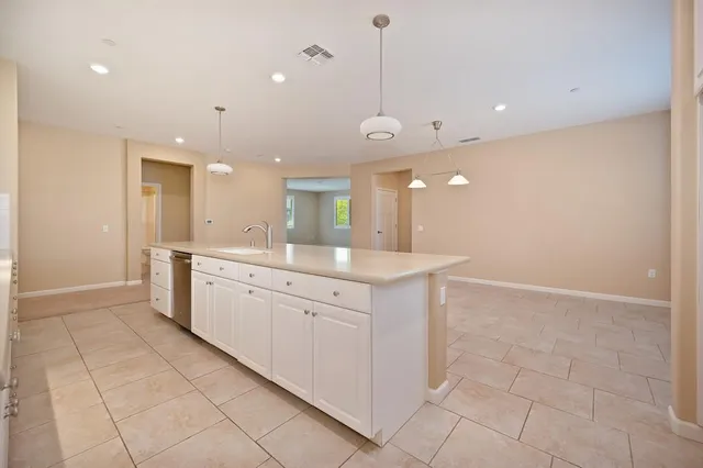 a large bathroom with a large mirror vanity and a sink